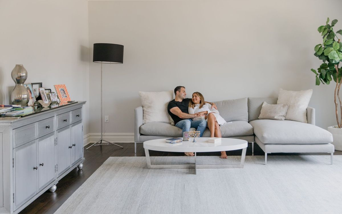 A couple sitting together on a modern sofa in a stylish living room.