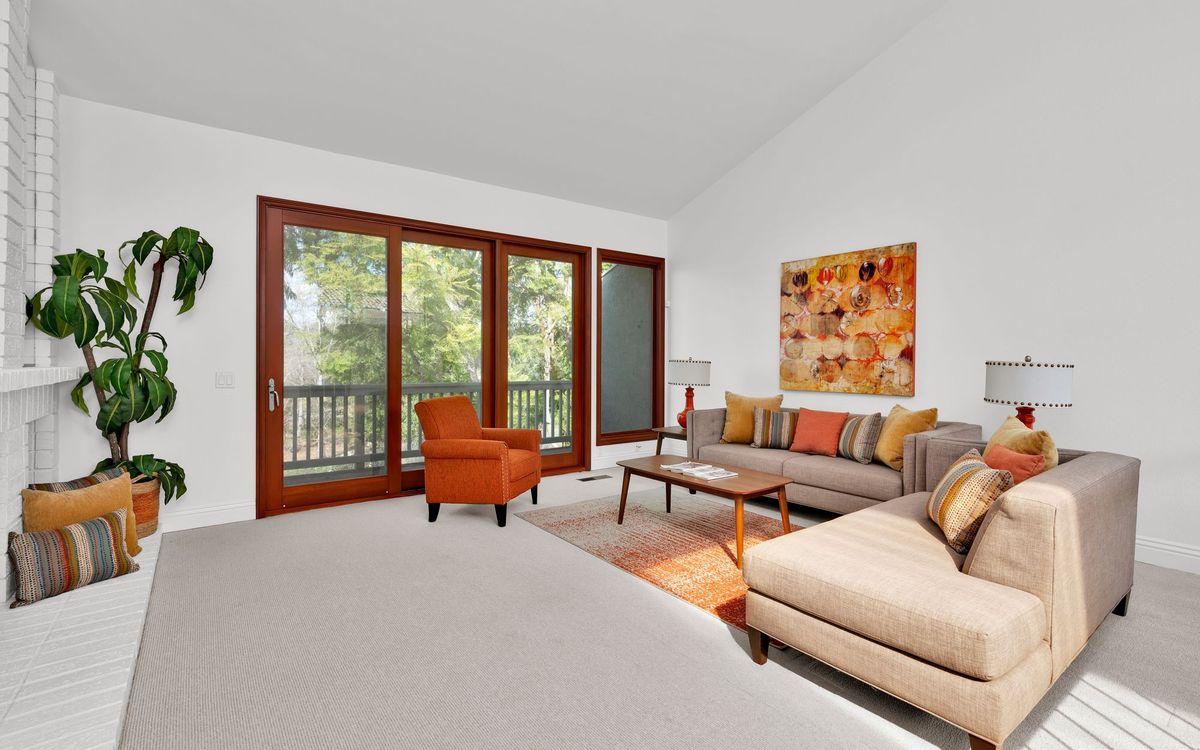 Bright and spacious living room with large windows, where large wall art would suit the open wall space
