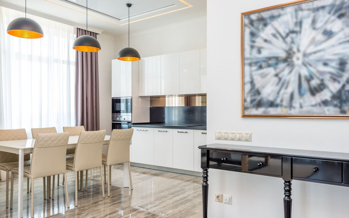 Stylish modern dining room and kitchen with sleek furniture and elegant decor